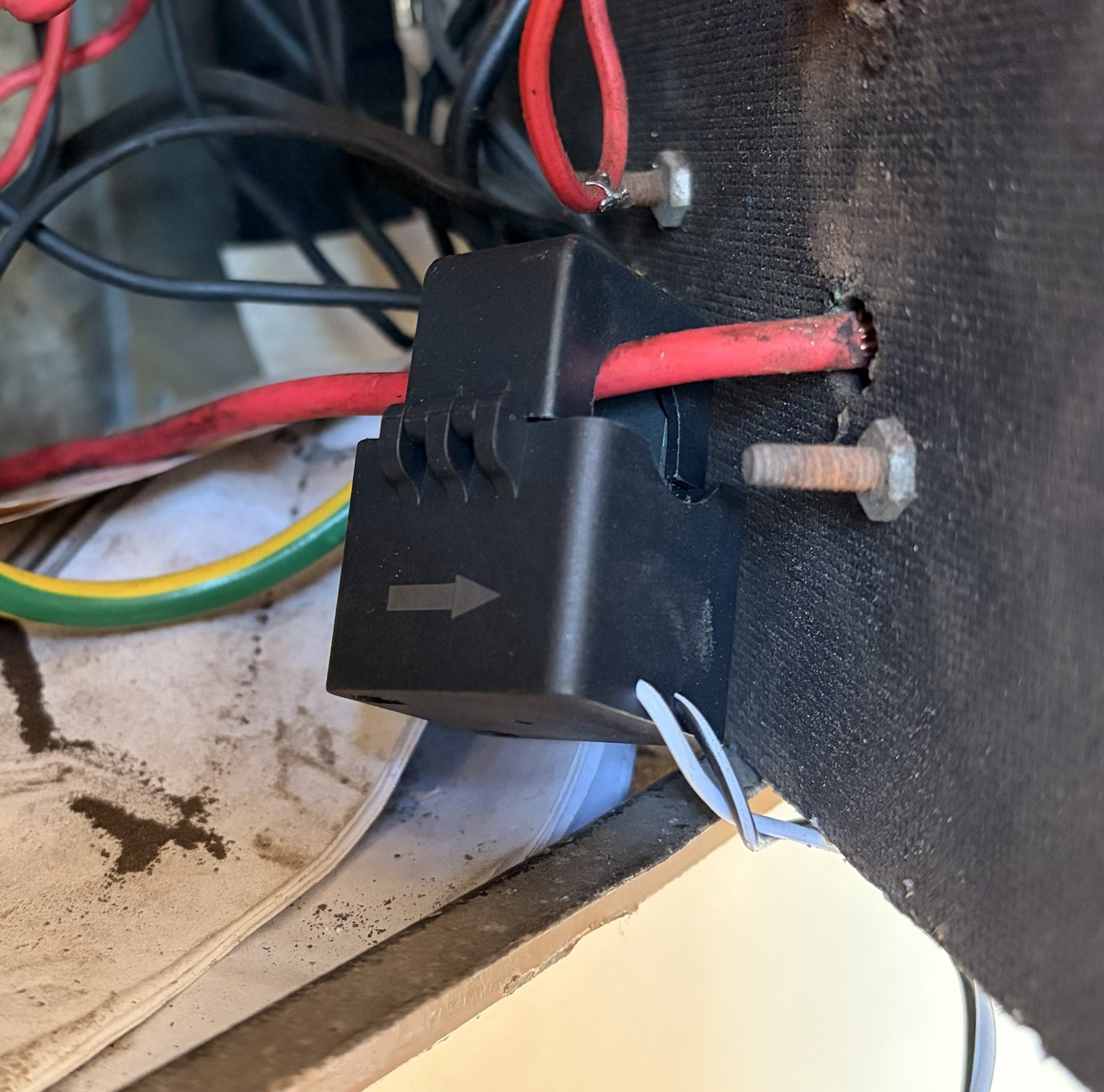 CT clamp installed on incoming mains showing directional arrow